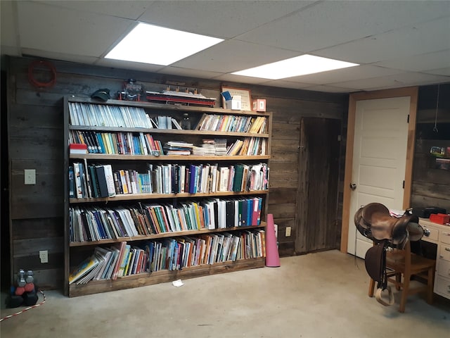 314 4th Ave NE, Cut Bank, MT 59427 - miscellaneous room with wood walls, a paneled ceiling, and concrete floors