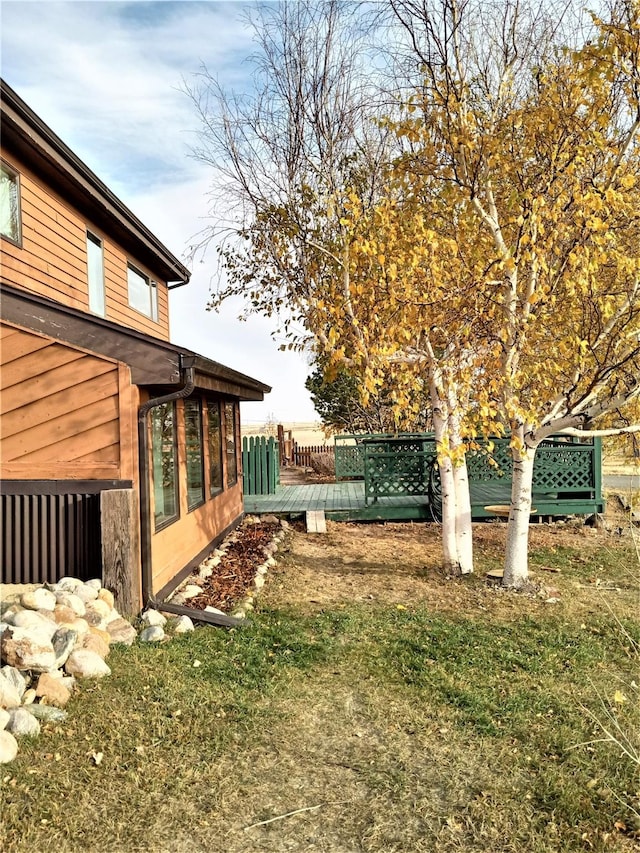 314 4th Ave NE, Cut Bank, MT 59427 - view of yard featuring a wooden deck and a sunroom