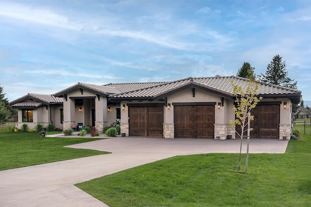 344 Chapman Ln, Bigfork, MT 59911 - view of front of property featuring stone siding, stucco siding, an attached garage, driveway, and a tiled roof