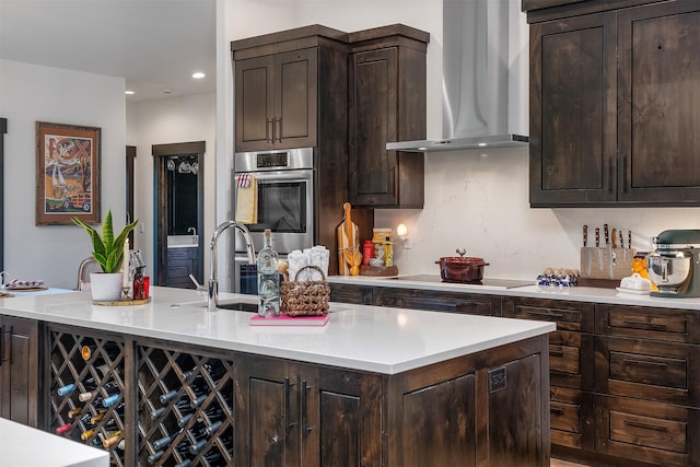 344 Chapman Ln, Bigfork, MT 59911 - kitchen with wall chimney range hood, black electric cooktop, stainless steel oven, dark brown cabinets, and recessed lighting