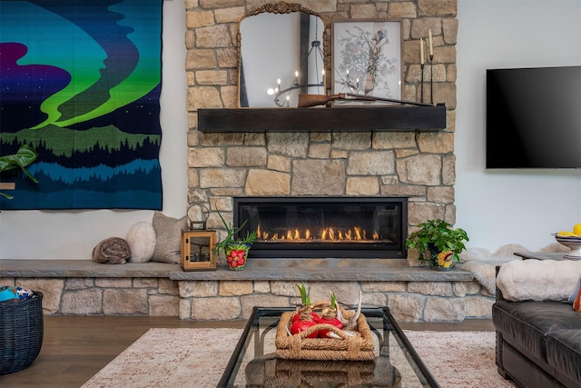 344 Chapman Ln, Bigfork, MT 59911 - living room featuring wood finished floors and a stone fireplace