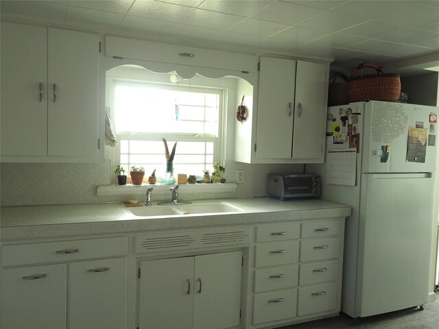 15 Perrin Ln, Hot Springs, MT 59845 - kitchen with freestanding refrigerator, a sink, light countertops, and white cabinets