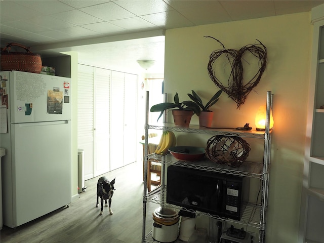 15 Perrin Ln, Hot Springs, MT 59845 - kitchen featuring freestanding refrigerator, wood finished floors, and black microwave