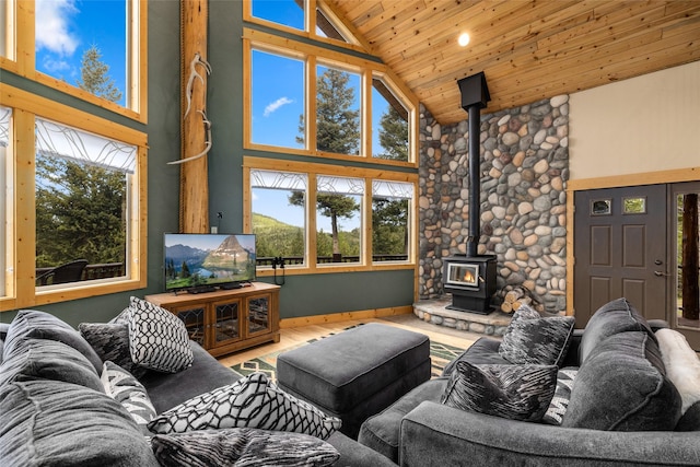 217 Forest Ridge Trl, Kila, MT 59920 - living room featuring a wood stove, high vaulted ceiling, plenty of natural light, wooden ceiling, and wood finished floors
