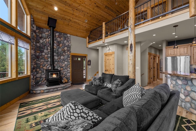217 Forest Ridge Trl, Kila, MT 59920 - living area with a towering ceiling, a wood stove, baseboards, recessed lighting, and light wood-style flooring