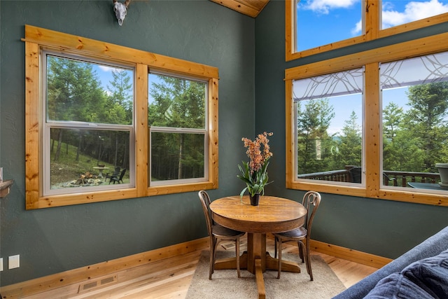 217 Forest Ridge Trl, Kila, MT 59920 - dining space with wood finished floors, baseboards, and lofted ceiling