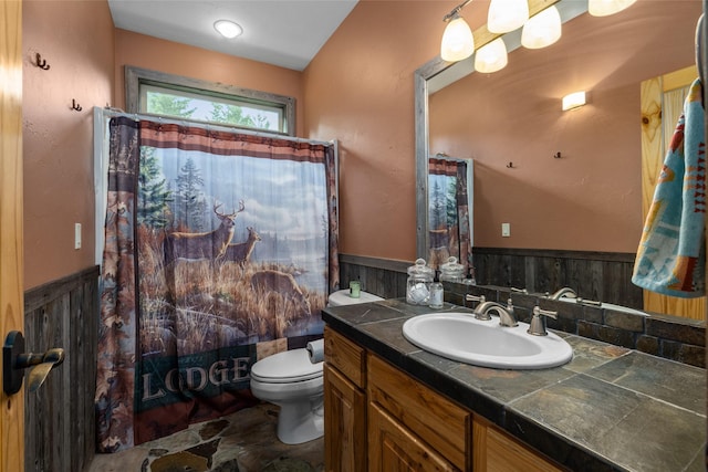 217 Forest Ridge Trl, Kila, MT 59920 - full bath with toilet, vanity, wainscoting, and shower / tub combo with curtain
