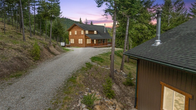 217 Forest Ridge Trl, Kila, MT 59920 - view of home's exterior with gravel driveway and roof with shingles
