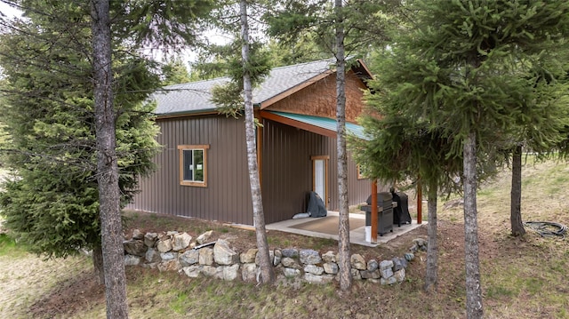 217 Forest Ridge Trl, Kila, MT 59920 - view of side of home featuring roof with shingles and a patio area