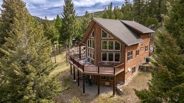 217 Forest Ridge Trl, Kila, MT 59920 - back of house with a view of trees, roof with shingles, and a wooden deck