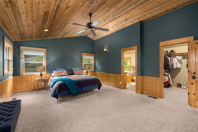 217 Forest Ridge Trl, Kila, MT 59920 - carpeted bedroom with wainscoting, lofted ceiling, wooden walls, multiple windows, and wood ceiling