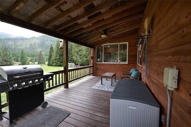2 Cedar Grove Ln, Noxon, MT 59853 - wooden terrace with a wooded view, a grill, a mountain view, and a ceiling fan