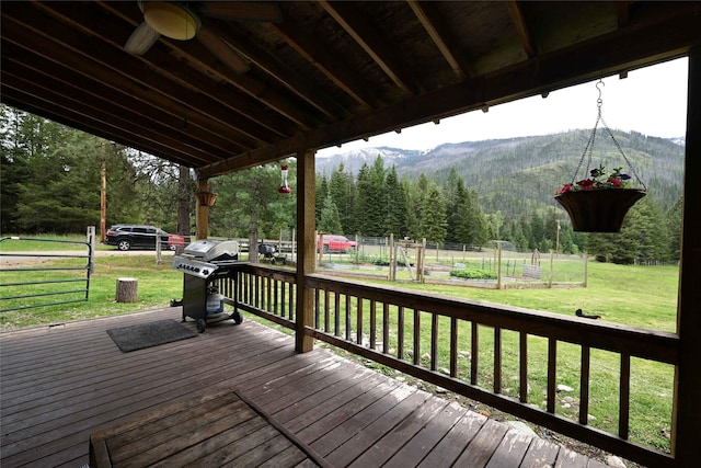 2 Cedar Grove Ln, Noxon, MT 59853 - wooden deck featuring a view of trees, a ceiling fan, a vegetable garden, a mountain view, and area for grilling