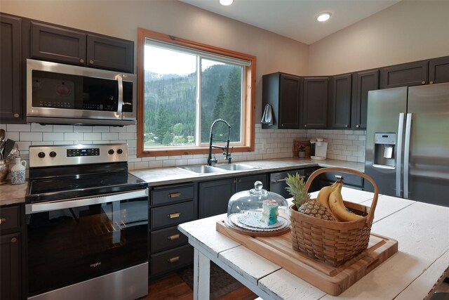 2 Cedar Grove Ln, Noxon, MT 59853 - living area featuring ceiling fan, vaulted ceiling, wood ceiling, a wood stove, and wood finished floors
