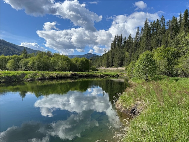 2 Cedar Grove Ln, Noxon, MT 59853 - water view featuring a mountain backdrop and a heavily wooded area