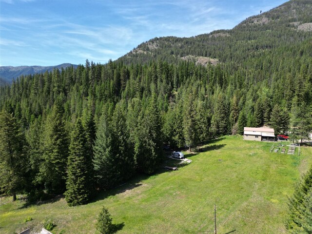2 Cedar Grove Ln, Noxon, MT 59853 - rear view of property featuring a lawn and a wooden deck