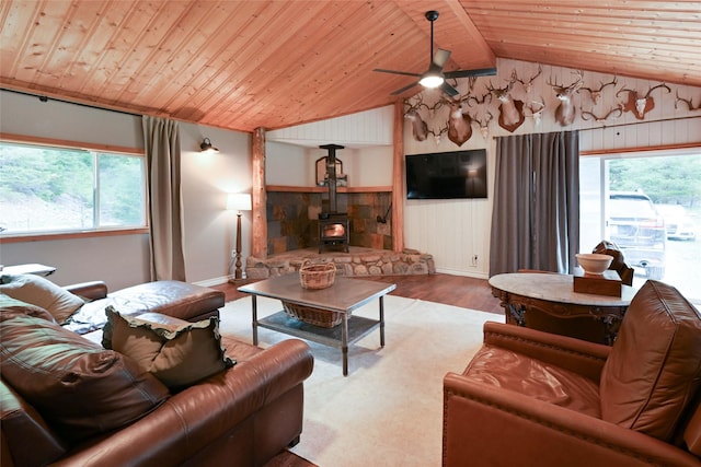 2 Cedar Grove Ln, Noxon, MT 59853 - living area featuring wooden ceiling, wood finished floors, a wood stove, vaulted ceiling, and healthy amount of natural light