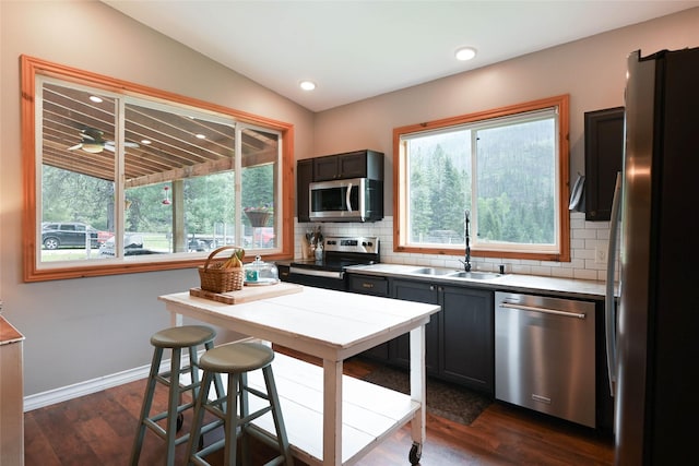 2 Cedar Grove Ln, Noxon, MT 59853 - kitchen featuring stainless steel appliances, a sink, tasteful backsplash, dark wood-style flooring, and vaulted ceiling
