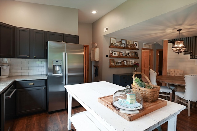 2 Cedar Grove Ln, Noxon, MT 59853 - kitchen with stainless steel appliances, light countertops, dark wood finished floors, tasteful backsplash, and pendant lighting