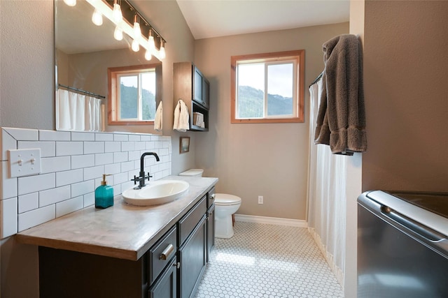 2 Cedar Grove Ln, Noxon, MT 59853 - bathroom featuring tasteful backsplash, vanity, toilet, and baseboards