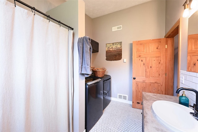 2 Cedar Grove Ln, Noxon, MT 59853 - full bathroom featuring washer and dryer, baseboards, a shower with shower curtain, and vanity