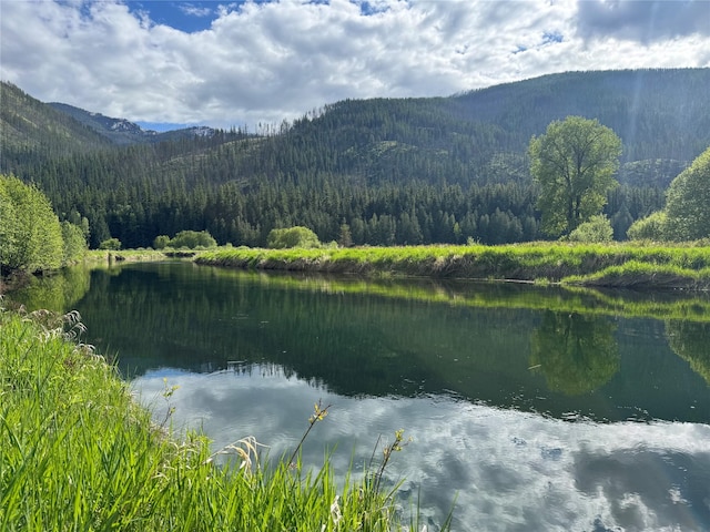 2 Cedar Grove Ln, Noxon, MT 59853 - water view featuring a heavily wooded area and a mountainous background
