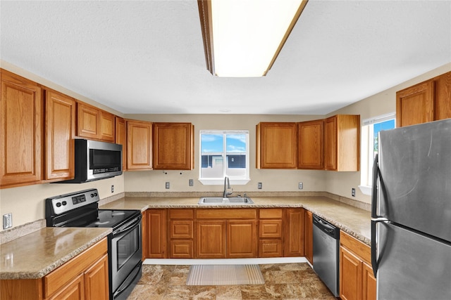 1721 13th Ave S, Great Falls, MT 59405 - kitchen with appliances with stainless steel finishes, a sink, and brown cabinetry