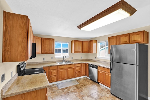 1721 13th Ave S, Great Falls, MT 59405 - kitchen featuring stainless steel appliances, a sink, and brown cabinets
