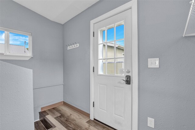 1721 13th Ave S, Great Falls, MT 59405 - doorway to outside featuring wood finished floors, plenty of natural light, baseboards, and a textured wall