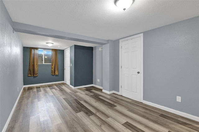 1721 13th Ave S, Great Falls, MT 59405 - unfurnished room with wood finished floors, a textured ceiling, baseboards, and a textured wall