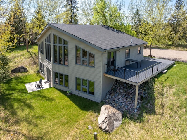 550 Talbot Rd, Columbia Falls, MT 59912 - back of house with a patio area, a yard, a shingled roof, and a wooden deck