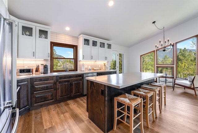 550 Talbot Rd, Columbia Falls, MT 59912 - kitchen with a sink, stainless steel appliances, backsplash, a kitchen breakfast bar, and recessed lighting