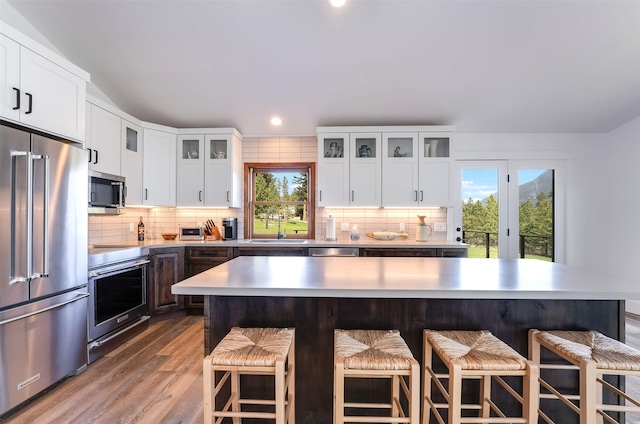 550 Talbot Rd, Columbia Falls, MT 59912 - kitchen featuring stainless steel appliances, a sink, tasteful backsplash, a breakfast bar area, and recessed lighting