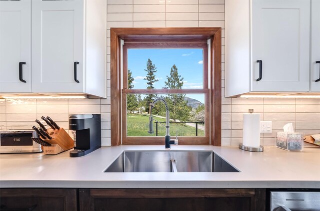550 Talbot Rd, Columbia Falls, MT 59912 - kitchen with a sink, light countertops, dishwasher, and decorative backsplash
