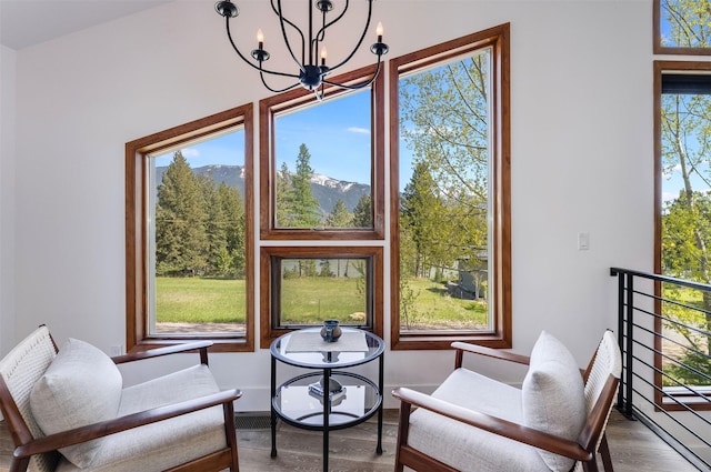 550 Talbot Rd, Columbia Falls, MT 59912 - living area featuring a chandelier, wood finished floors, and a mountain view