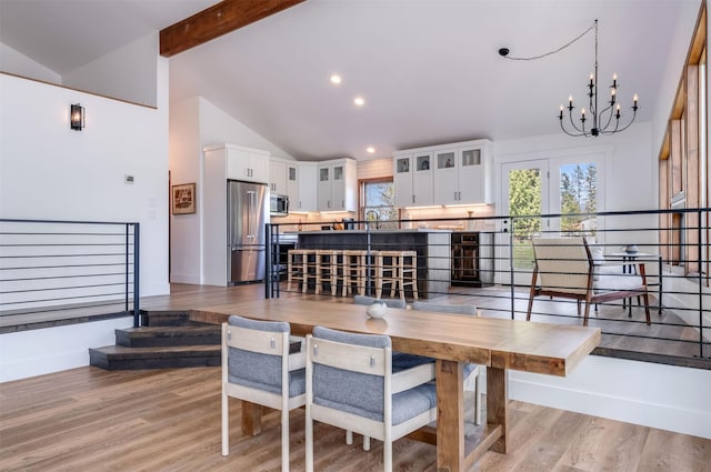 550 Talbot Rd, Columbia Falls, MT 59912 - dining area featuring a chandelier, light wood-style flooring, beamed ceiling, recessed lighting, and high vaulted ceiling