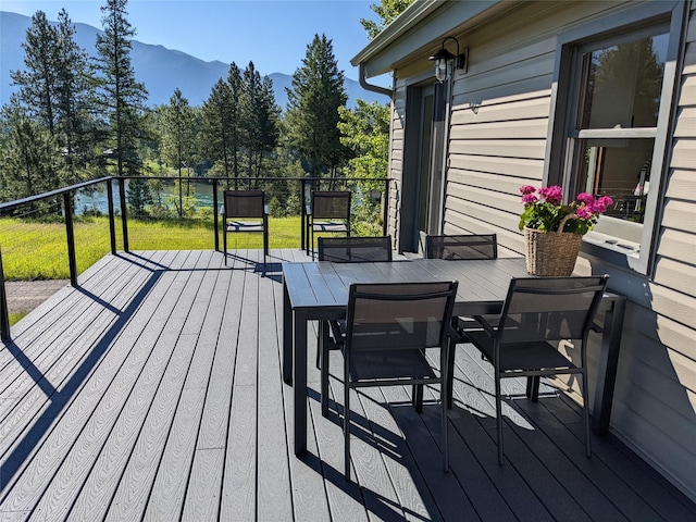 550 Talbot Rd, Columbia Falls, MT 59912 - wooden deck with a mountain view and outdoor dining space