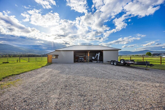 17 River Runs Ct, Plains, MT 59859 - view of pole building featuring a mountain view, a carport, a view of countryside, and gravel driveway