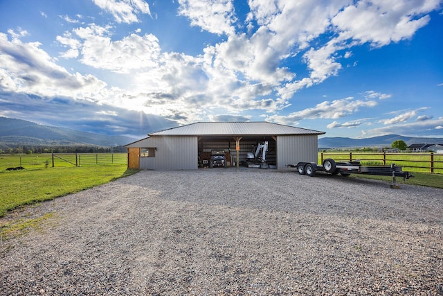 17 River Runs Ct, Plains, MT 59859 - view of pole building featuring a mountain view, a carport, a view of countryside, and gravel driveway
