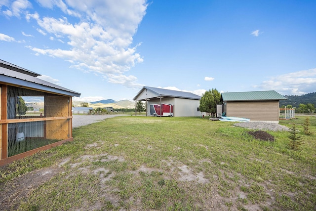 17 River Runs Ct, Plains, MT 59859 - view of grassy yard with a mountain view and an outdoor structure