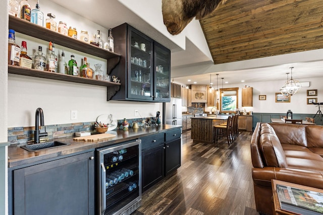 17 River Runs Ct, Plains, MT 59859 - indoor wet bar featuring beverage cooler, dark wood-style floors, high quality fridge, decorative light fixtures, and lofted ceiling