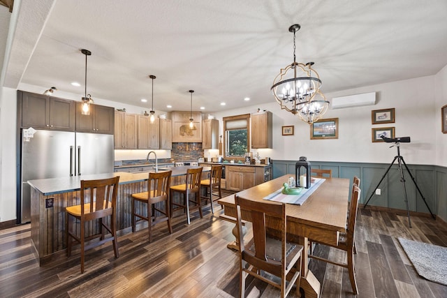 17 River Runs Ct, Plains, MT 59859 - dining room with a wall mounted air conditioner, dark wood-style flooring, recessed lighting, a chandelier, and wainscoting