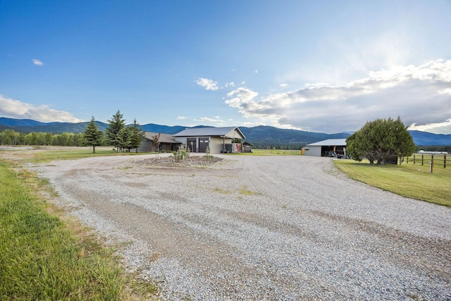 17 River Runs Ct, Plains, MT 59859 - view of front facade featuring a mountain view, driveway, a view of rural / pastoral area, and a garage