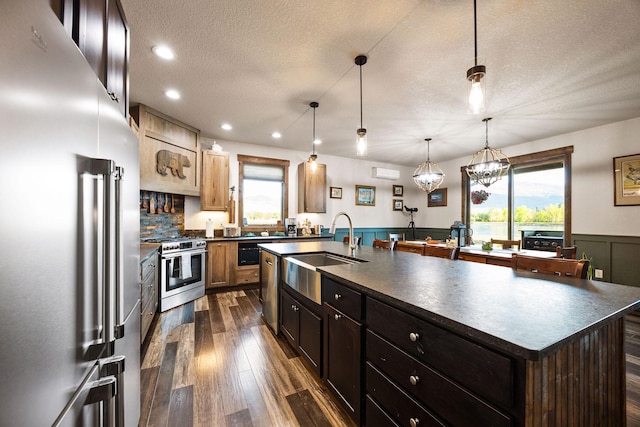 17 River Runs Ct, Plains, MT 59859 - kitchen featuring appliances with stainless steel finishes, dark countertops, a sink, a textured ceiling, and plenty of natural light