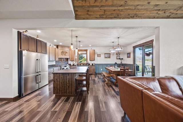 17 River Runs Ct, Plains, MT 59859 - kitchen with appliances with stainless steel finishes, a chandelier, dark wood-type flooring, open floor plan, and a kitchen bar