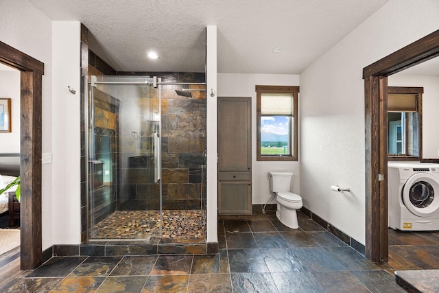 17 River Runs Ct, Plains, MT 59859 - bathroom featuring washer / dryer, stone tile floors, a shower stall, recessed lighting, and a textured ceiling