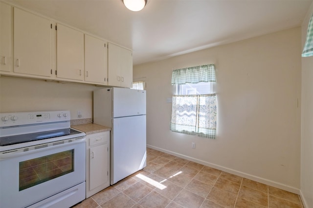 925 Hollins Ave, Helena, MT 59601 - kitchen featuring white appliances, light countertops, baseboards, white cabinets, and light tile patterned floors