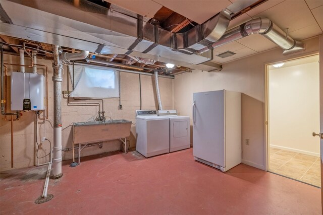 925 Hollins Ave, Helena, MT 59601 - below grade area with freestanding refrigerator, washing machine and dryer, tankless water heater, and a sink