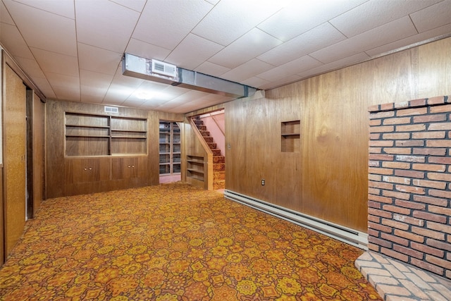 925 Hollins Ave, Helena, MT 59601 - finished basement featuring wooden walls, a baseboard heating unit, stairs, and carpet