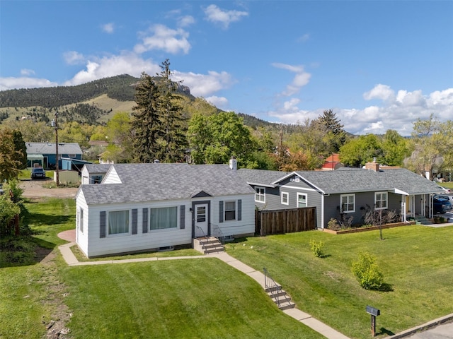 925 Hollins Ave, Helena, MT 59601 - ranch-style house with a mountain view, a front yard, and a shingled roof